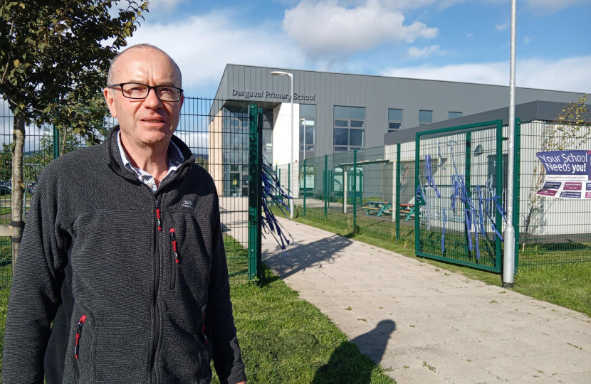 Councillor James MacLaren standing outside Dargavel Primary School