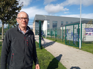 Councillor James MacLaren standing outside Dargavel Primary School